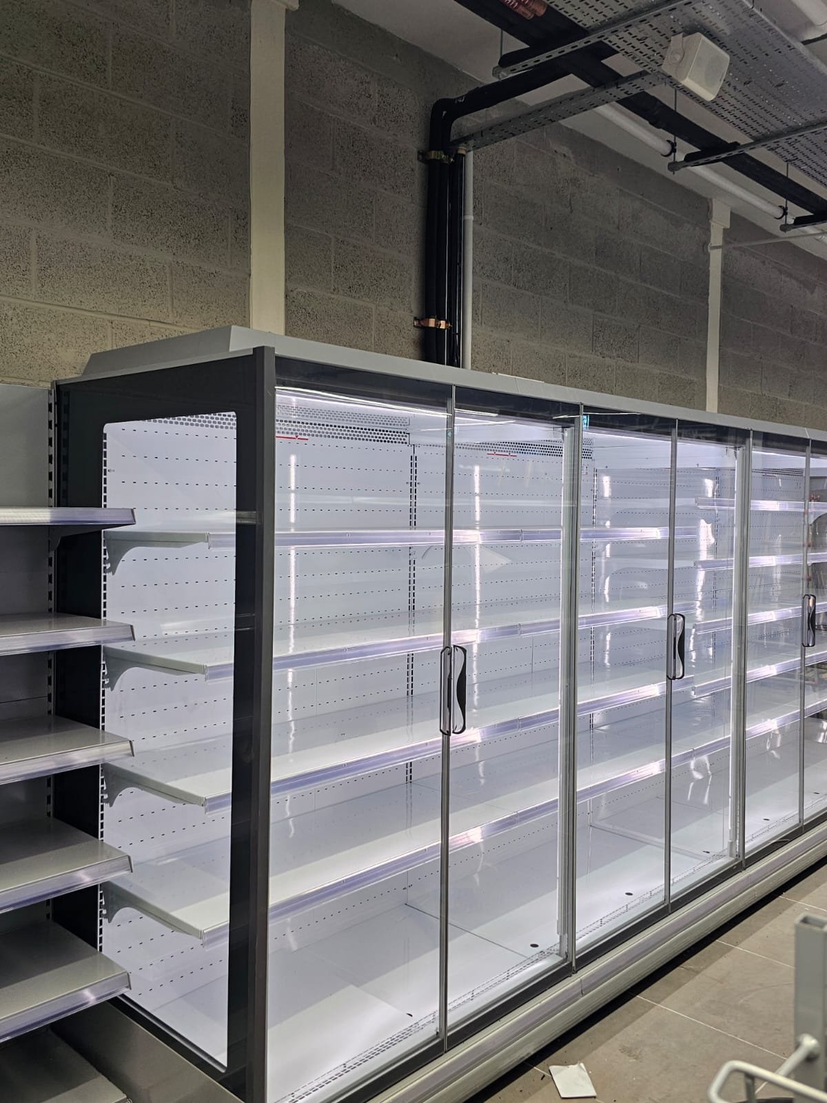 Commercial refrigeration installation with energy-efficient LED lighting in a retail store by U & O Electrical Manchester